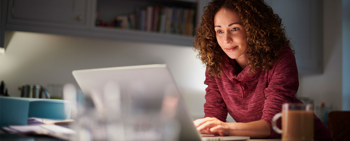 Woman working at computer in a home setting